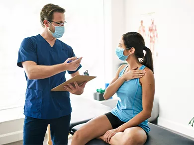 A Male Physical Therapist Stretching a Female Patient Slowly.