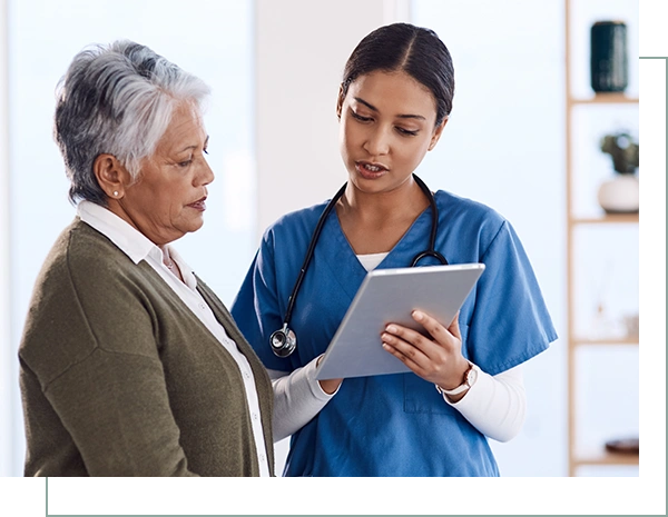 Shot of a young doctor using a digital tablet during a consultation with a senior woman.