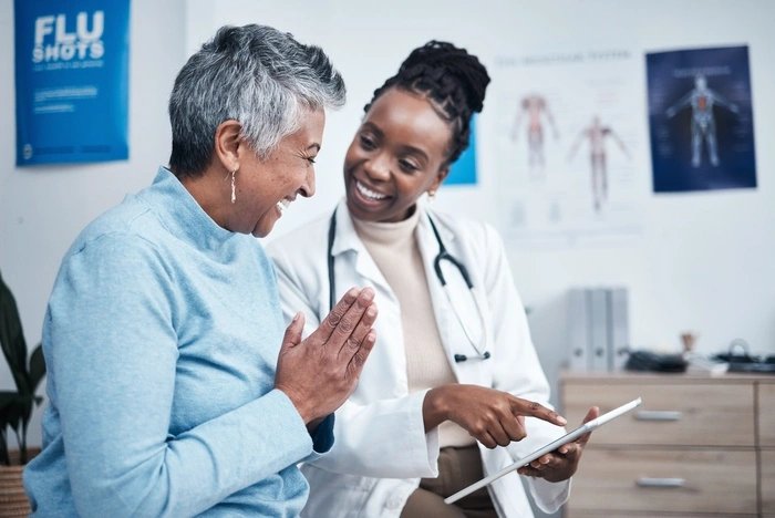 Black woman, doctor and elderly patient with good news, tablet and results for health