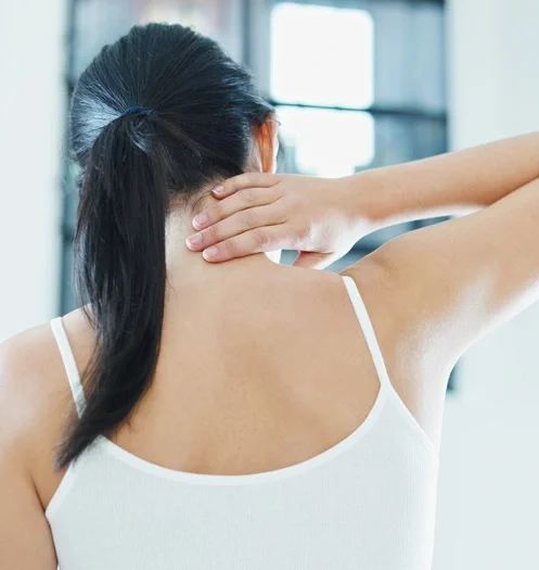 woman massaging neck. Rear view, copy space
