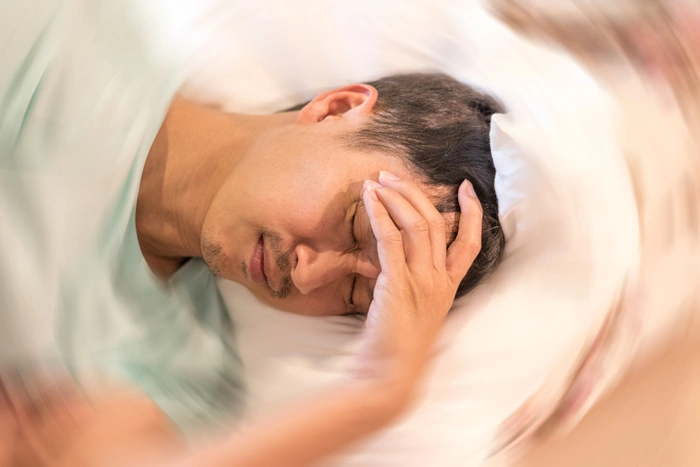 Vertigo illness concept. Man hands on his head felling headache dizzy sense of spinning dizziness